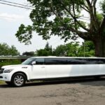 White stretch limousine parked on a suburban street