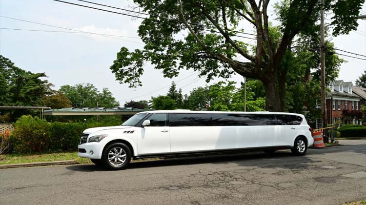 White stretch limousine parked on a suburban street