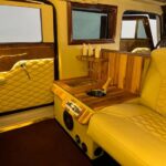 Luxury yellow leather limousine interior with wooden champagne bar
